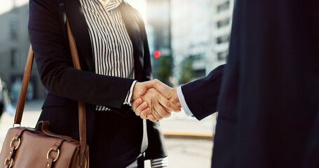 Business people, handshake and city for greeting, partnership or agreement in outdoor deal or...
