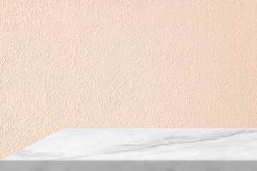 White Marble Table Corner with Light Beam through the Window from the left on Stucco Wall Texture Background in Peach Fuzz Color, Suitable for Product Presentation Backdrop, Display, and Mock up.