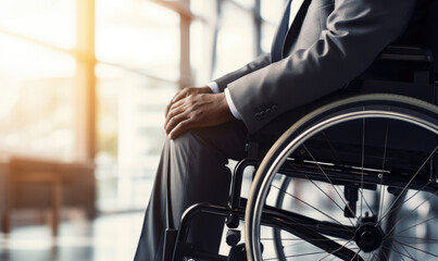 Obraz premium A disabled, businessman sits in a boardroom in a bright glass room