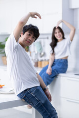 Happy portrait of cheerful young loving couple asian of having fun heart-shaped hand gesture...