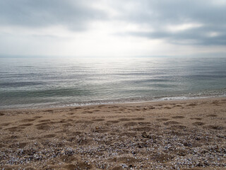 Landscape with beach, sea and cloudy dramatic sky