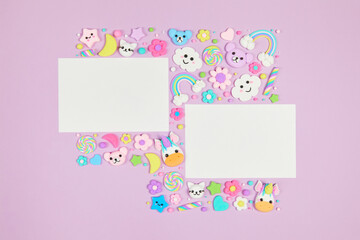 Two blank white cards on pastel purple background with frame of cute kawaii air plasticine handmade...