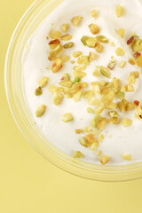 dessert with cream cheese and pistachios in a clear glass