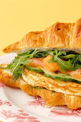 French croissant with salmon, spinach and egg