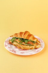 French croissant with salmon, spinach and egg
