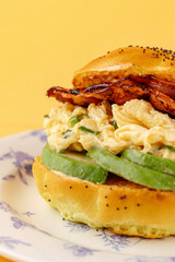 bagel with avocado, sun-dried tomatoes and scramble