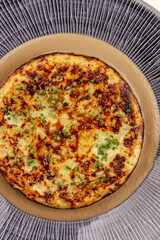 baked omelet with vegetables on a plate