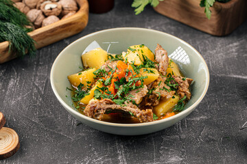 Portion of prepared stewed potatoes with meat