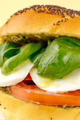 bagel with tomatoes, mozzarella, spinach and pesto sauce