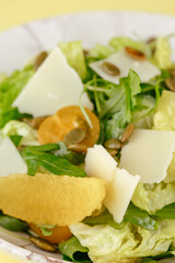 salad with oranges, pumpkin seeds and parmesan cheese