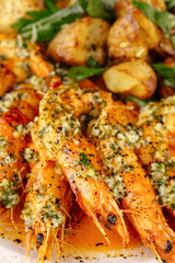 grilled shrimp with sauce and side dish on a plate