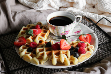 Closeup of waffle and coffee platter as a breakfast in bed