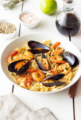 Tagliatelle pasta with shrimps and mussels. Seafood. Italian cuisine.