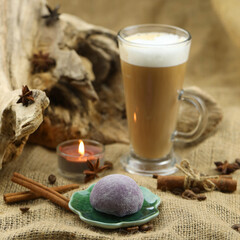 Glass coffee with mochi and spices. Cloth background with copy space
