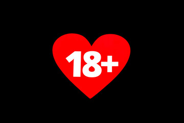 The inscription eighteen 18 plus on the background of a red heart on a black background.