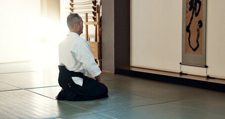 Asian man, sensei and bow in dojo for honor, greeting or respect to master at indoor gym. Male...