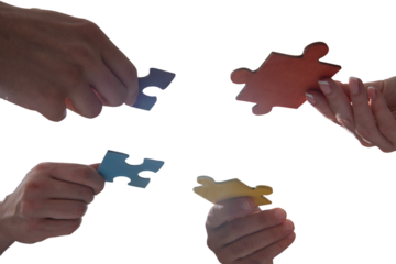 businessmen working together to build a puzzle as teamwork, partnership and integration concept