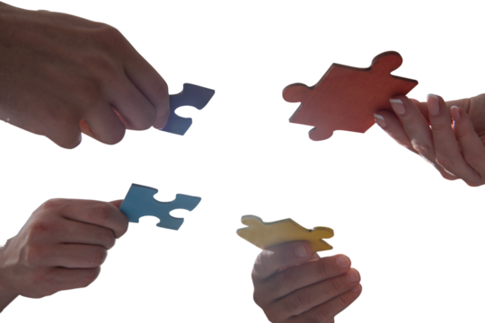 businessmen working together to build a puzzle as teamwork, partnership and integration concept