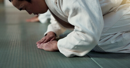 Asian man, student or bow in dojo for respect, greeting or honor to master at indoor gym. Closeup...