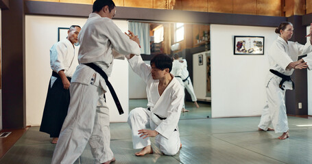Martial arts, sensei and Japanese students with training, fitness and action in class for defence...