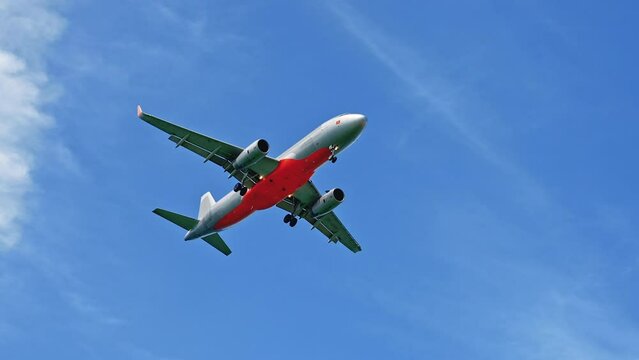 Commercial Airplane Flying in a Beautiful Blue Sky. Plane is Ready to Landing. Concept of Travel and Business