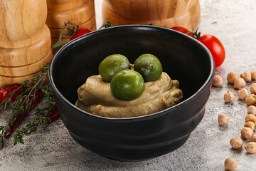 Tasty hummus with green olives