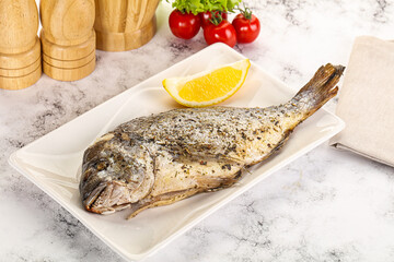 Baked Dorado fish served lemon