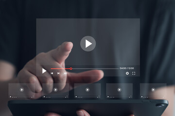 Man hand touch virtual video streaming on internet. Watching online movie, TV series, live concert, show or tutorial on tablet. Multimedia player. Subscription based live digital stream or channels. - obrazy, fototapety, plakaty