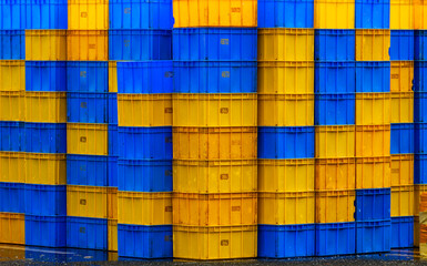 stack of blue and yellow plastic containers