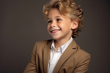 Portrait of a cute little boy in a suit. Studio shot.