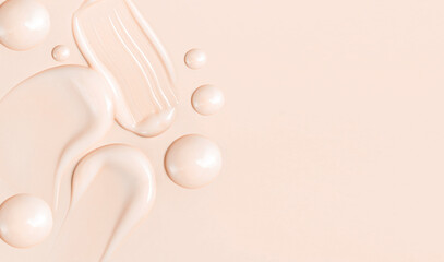 cosmetic smears texture on pastel beige background
