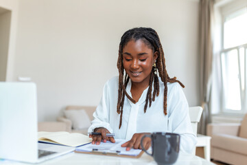 Remote job, technology and people concept - happy smiling young black business woman with laptop...