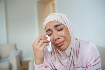Depressed Muslim lady in hijab headscarf, sadness and frustration, crying woman, despair emotions expression The life of a woman in the Muslim world is doomed to live in fear and suffering.