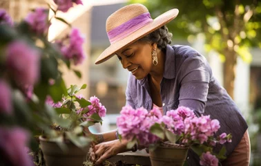 Foto op Canvas a woman is wearing a hat while doing gardening © ArtCookStudio
