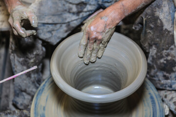 Potter's hands mold clay on a potter's wheel for planting plants. Environmentally friendly products made by human hands,Stay home and work from home.