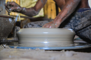 Potter's hands mold clay on a potter's wheel for planting plants. Environmentally friendly products made by human hands,Stay home and work from home.