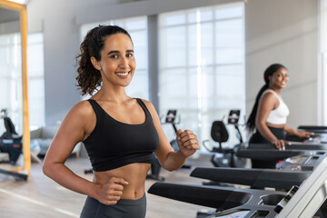woman sportwear exercise running treadmill fitness in gym health club. sportswoman slim motivation run fitness calories burn.