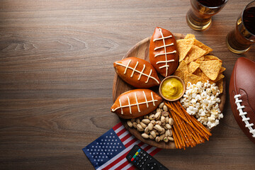 A bowl with various snacks, a remote control and an American flag