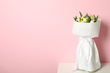 A bouquet of fresh tulips on a light background
