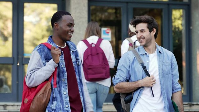 African American student walking with university friend after classes