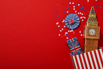 Big Ben and the British flag on a red background. - obrazy, fototapety, plakaty