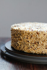 Caramel Nut Cake. Crumbled natural nuts soaked in caramel filling. Its topping on the cake is spread with caramel whipped cream  and cream cheese and roasted diced nuts.