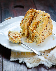 Slice Caramel Nut Cake. Crumbled natural nuts soaked in caramel filling. Its topping on the cake is spread with caramel whipped cream  and cream cheese and roasted diced nuts.