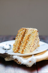 Slice Caramel Nut Cake. Crumbled natural nuts soaked in caramel filling. Its topping on the cake is spread with caramel whipped cream  and cream cheese and roasted diced nuts.