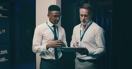 Server room, men and tablet with communication for database, information technology and training. Datacenter, mentor and employee with instructions to store and power computer hardware on system