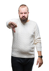 Young caucasian hipster man wearing winter sweater over isolated background looking unhappy and angry showing rejection and negative with thumbs down gesture. Bad expression.