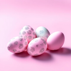 Simply decorated Easter eggs on a pink background.