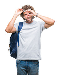 Handsome hispanic student man wearing backpack and glasses over isolated background doing ok gesture with hand smiling, eye looking through fingers with happy face.