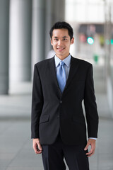 Fototapeta premium happy young Chinese business man in modern city