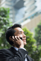 Chinese business man using a smartphone.